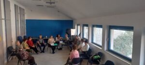 A résztvevők körben ülve hallgatják Matok Eleonórát, aki az Aviva tornáról beszél, jeltolmácsolás is látszik